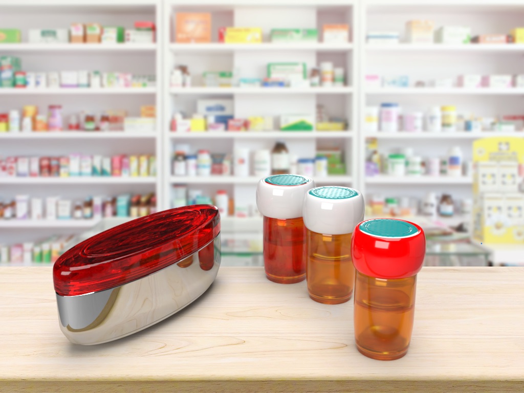 Render of Mavis MedBase: a red and chrome hub beside three amber pharmacy vials fitted with white and red smart caps, on a pharmacy counter.